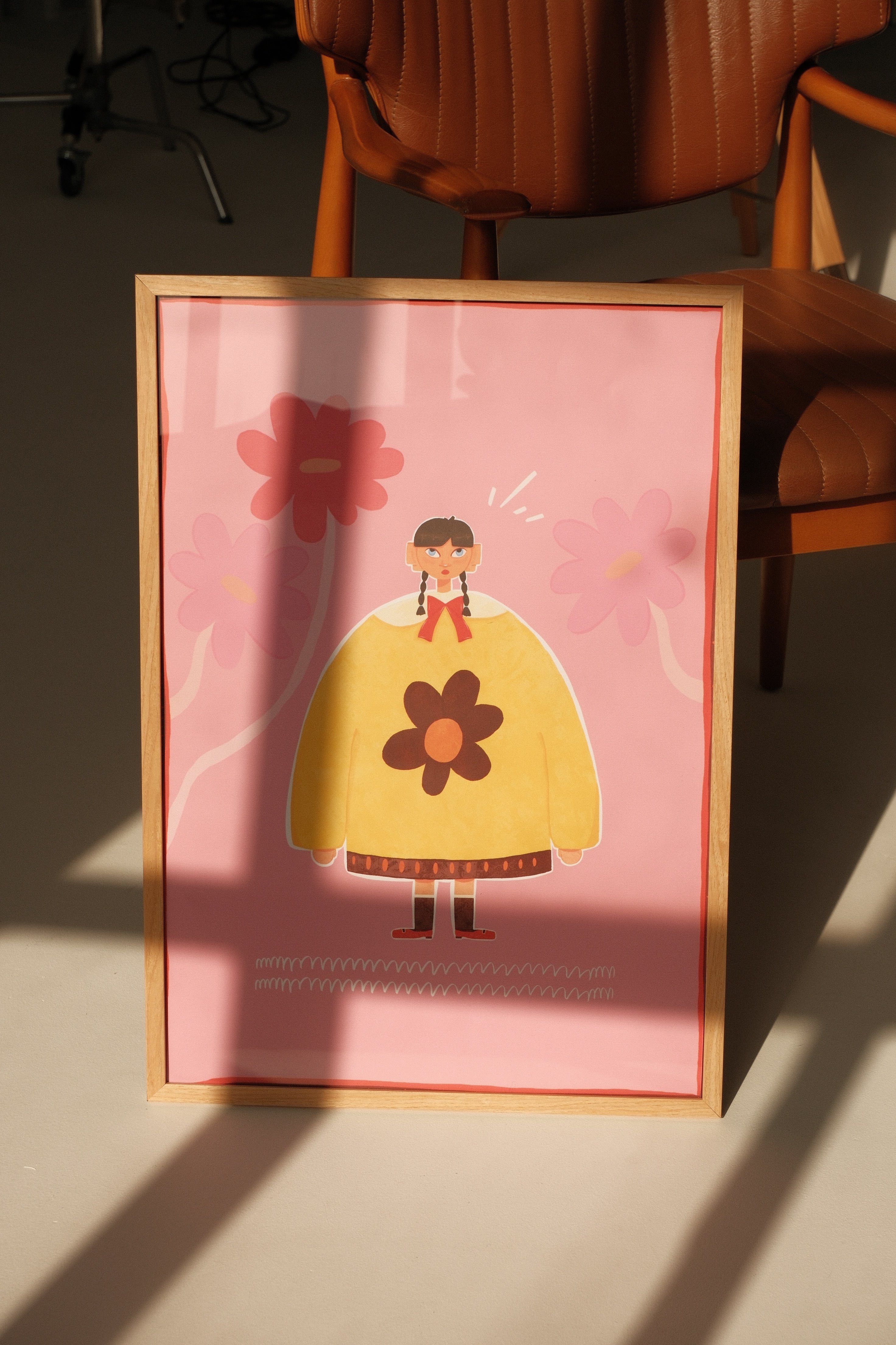 poster standing in studio, sunlight on it, standing in front of the chair.