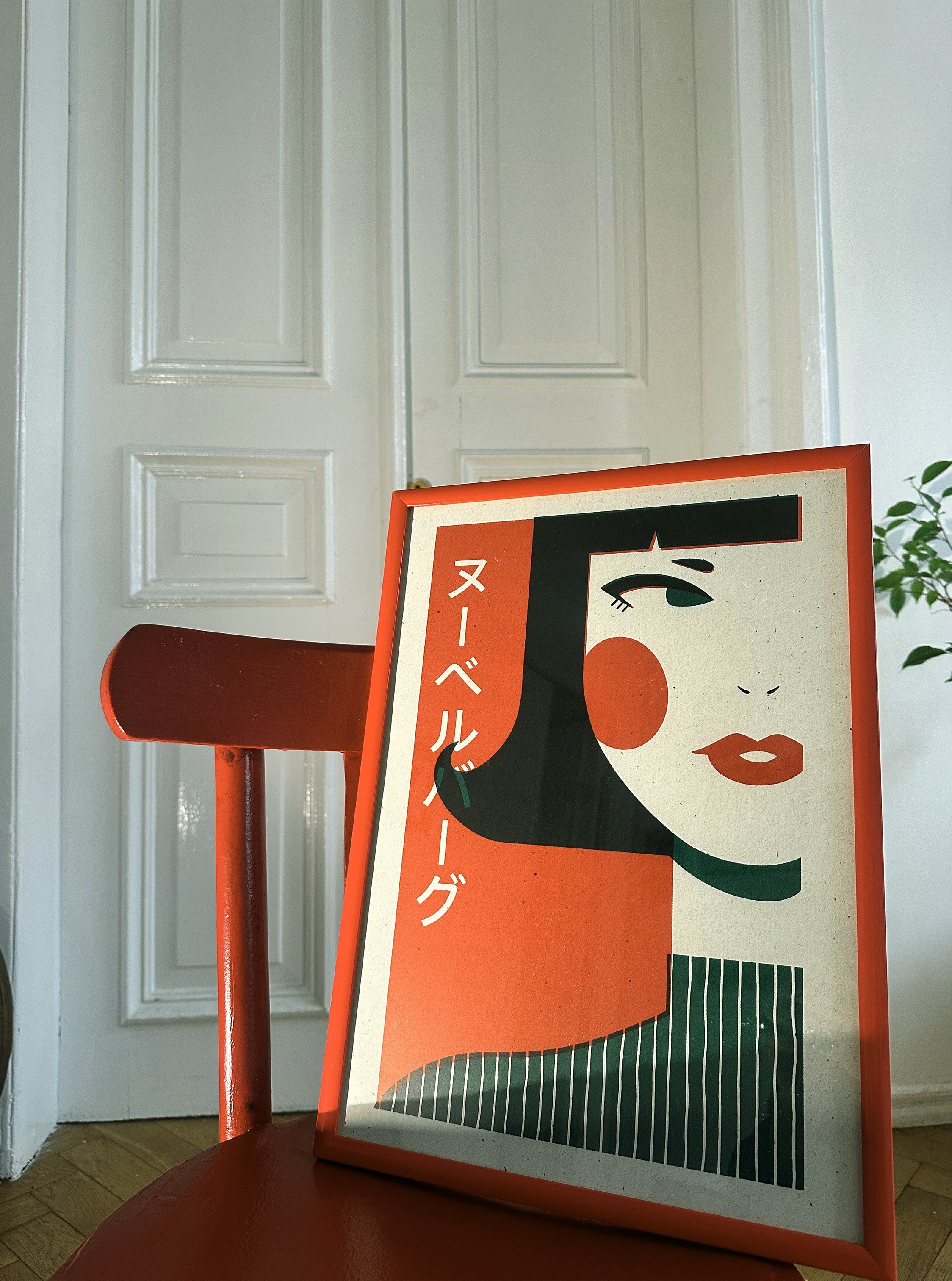 A poster featuring a stylized illustration of a woman with prominent red and black elements, leaning against a white door in a room with a red chair.