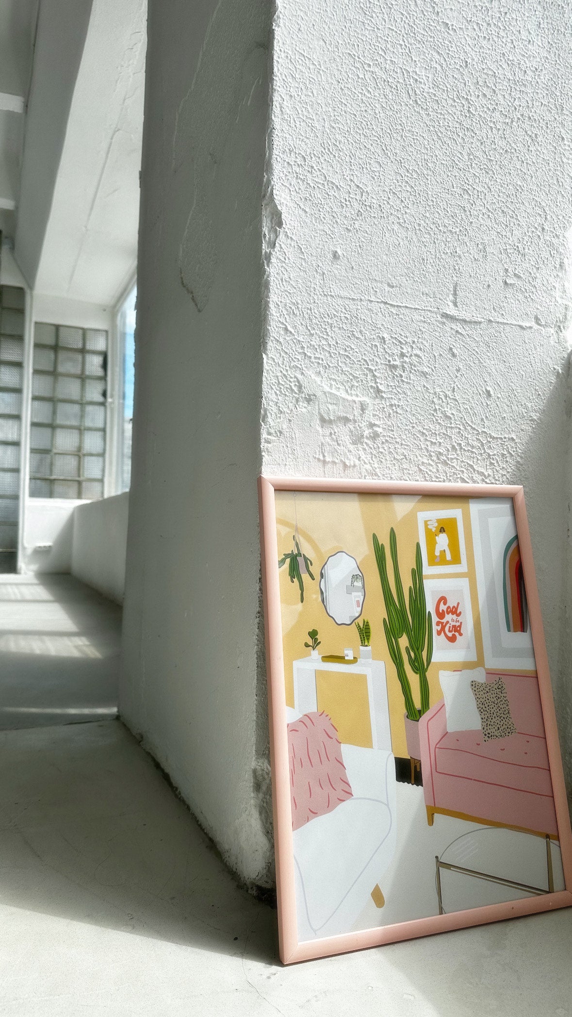 Framed “Cozy Home Interior” art poster leaning against a white wall in soft natural light.
