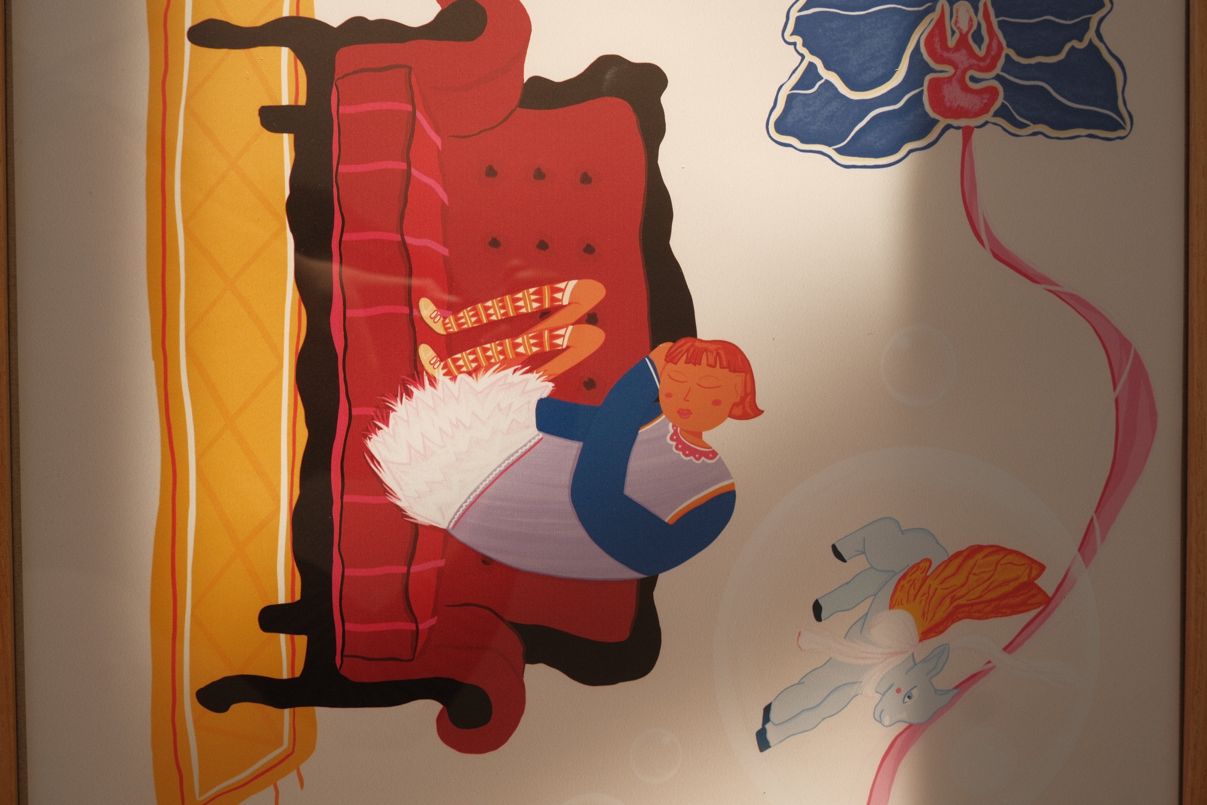 Cartoon-style illustration of a red couch with a white dog and blue cat, and a kite in the background.