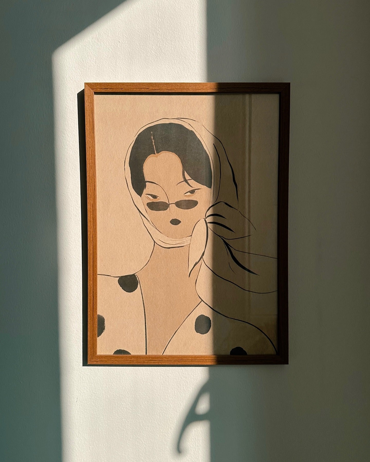 poster of dae on the wall with woman and sunglasses