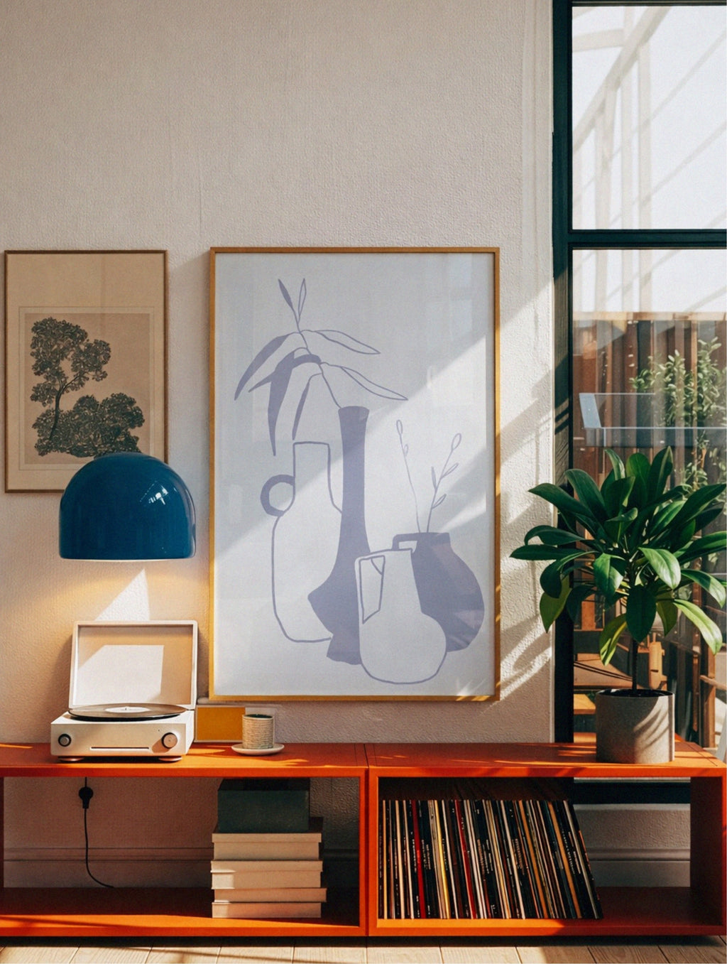 Wooden shelf with books, a plant, and decorative items in a room with natural light, poster by DAE above it