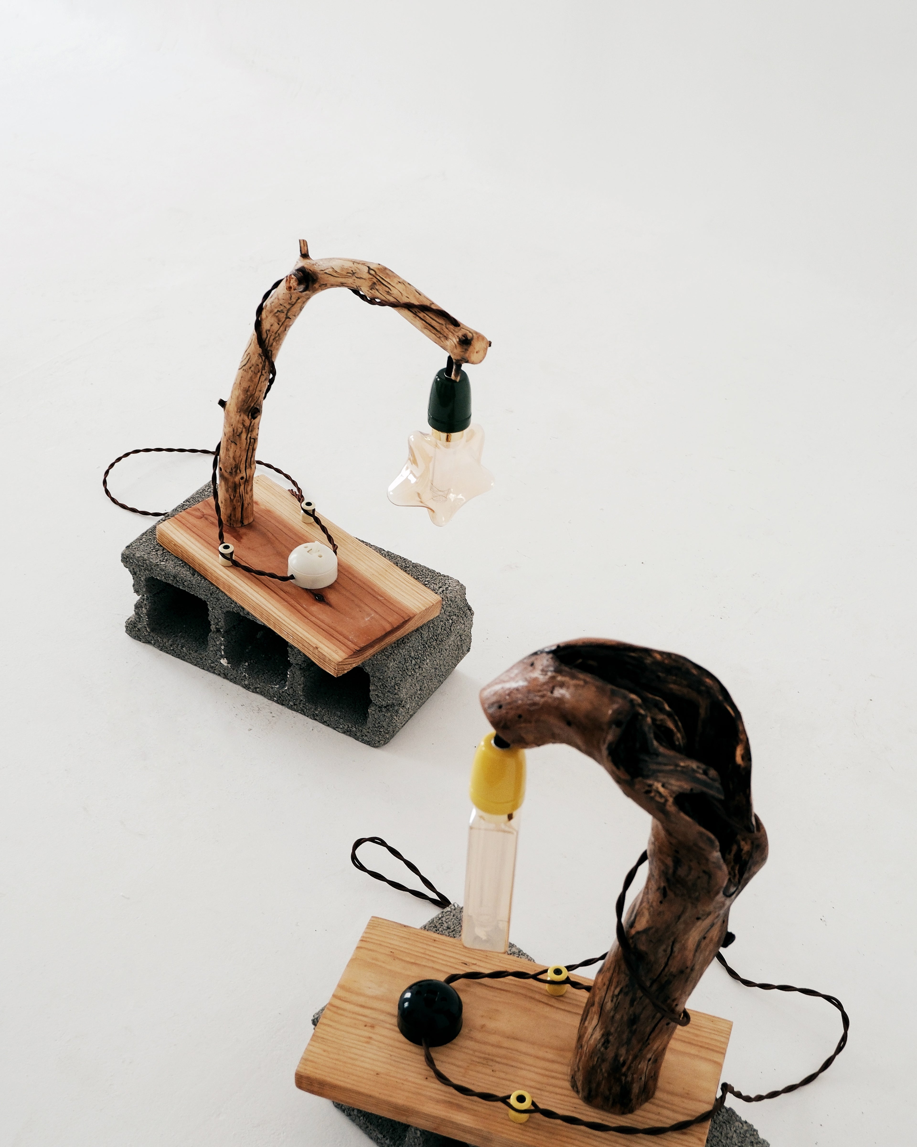 Two unique wooden and driftwood lamp designs on a white background