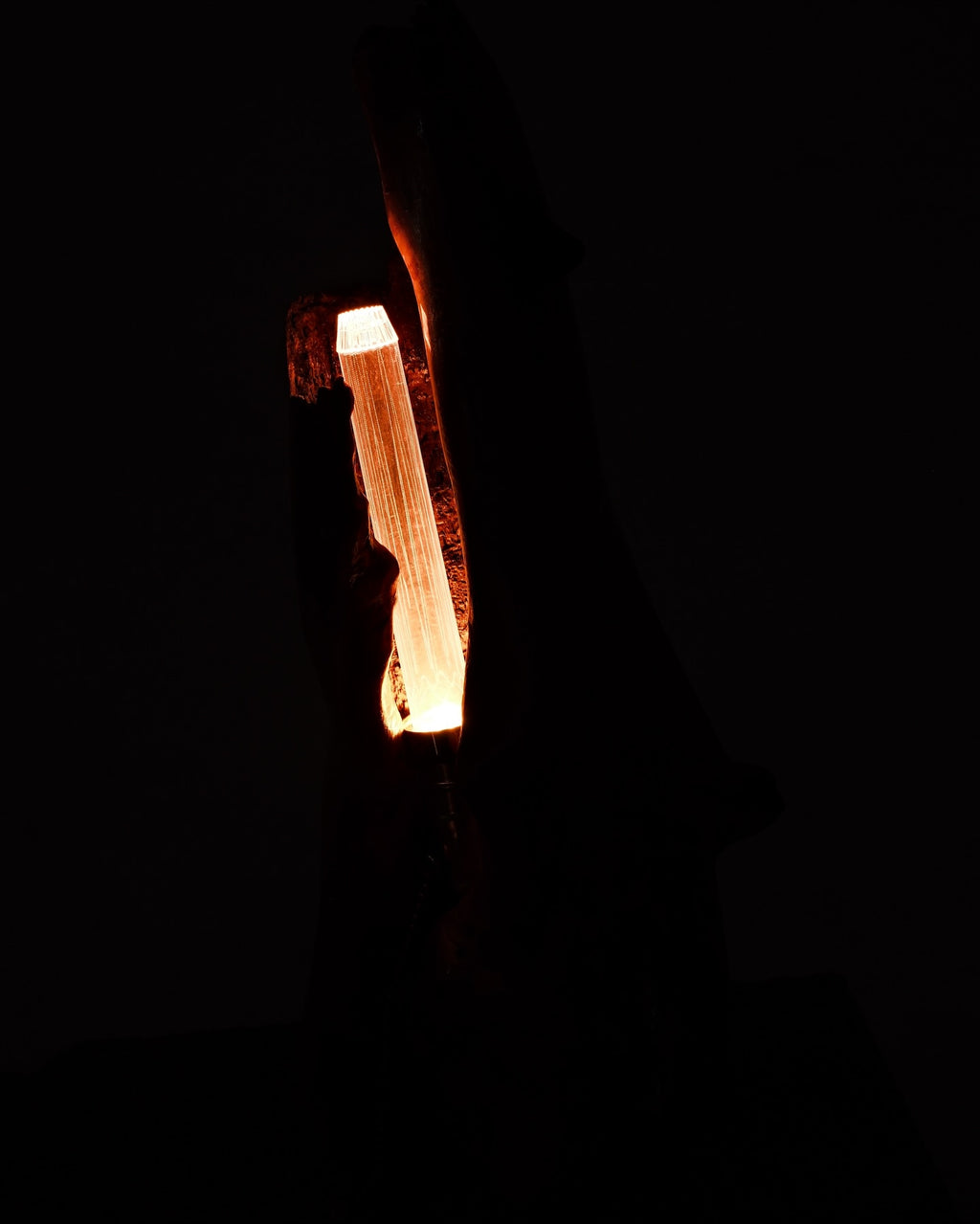 Light bulb filament glowing in the dark