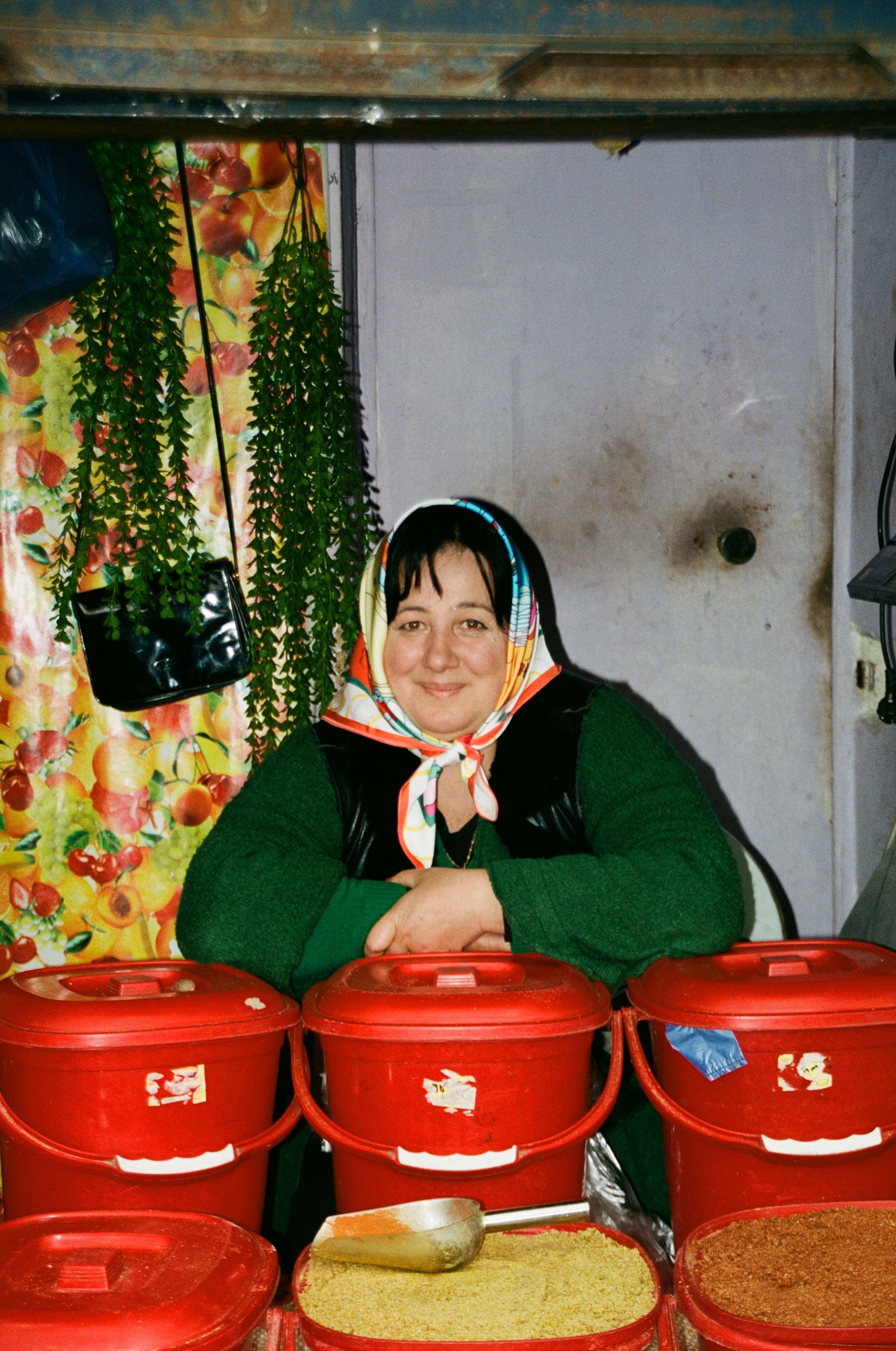 Model wearing Libra zodiac illustrated scarf with expressive cultural motifs, in bazaar
