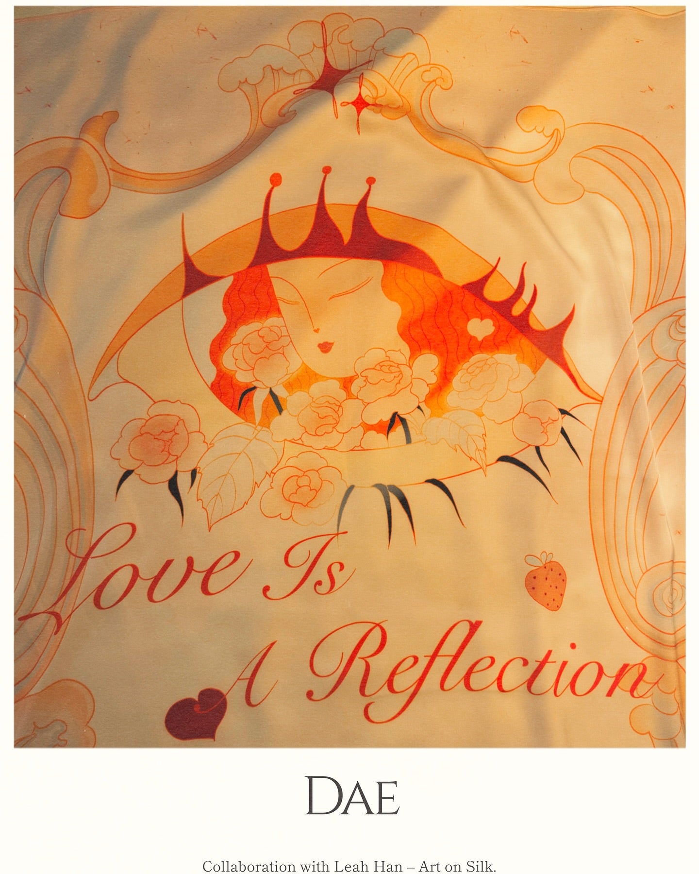 A scarf featuring a floral design with the text 'Love Is A Reflection' and the brand 'DAE' on it.