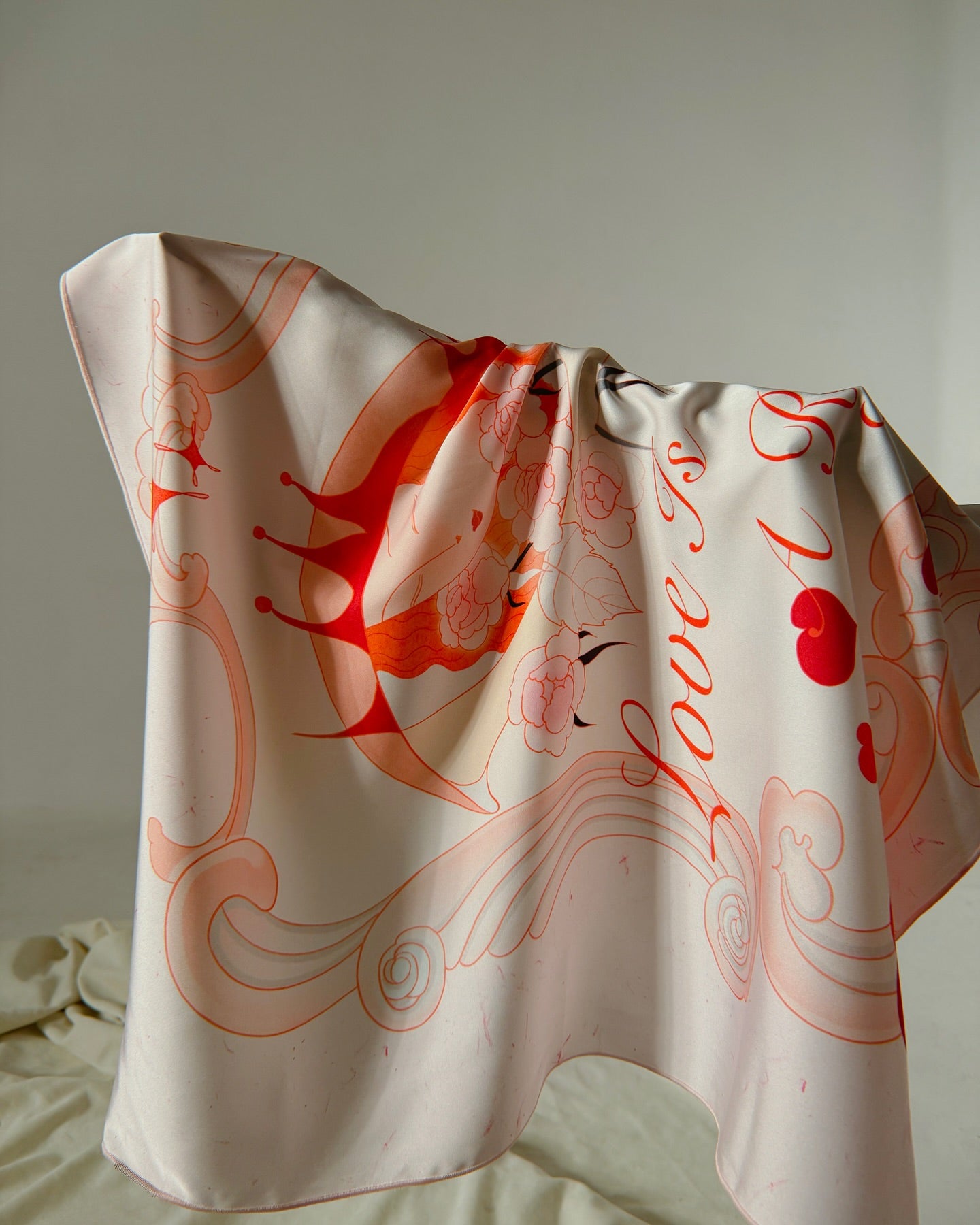Close-up of Love is a Reflection scarf showing symbolic shapes and warm colors