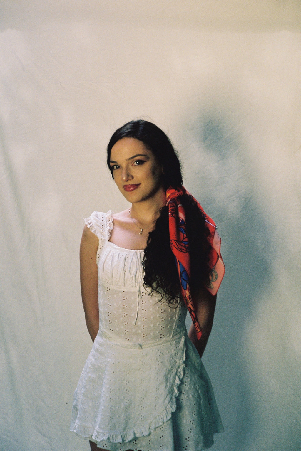 girl standing in front of white sheet, wearing scarf by DAE