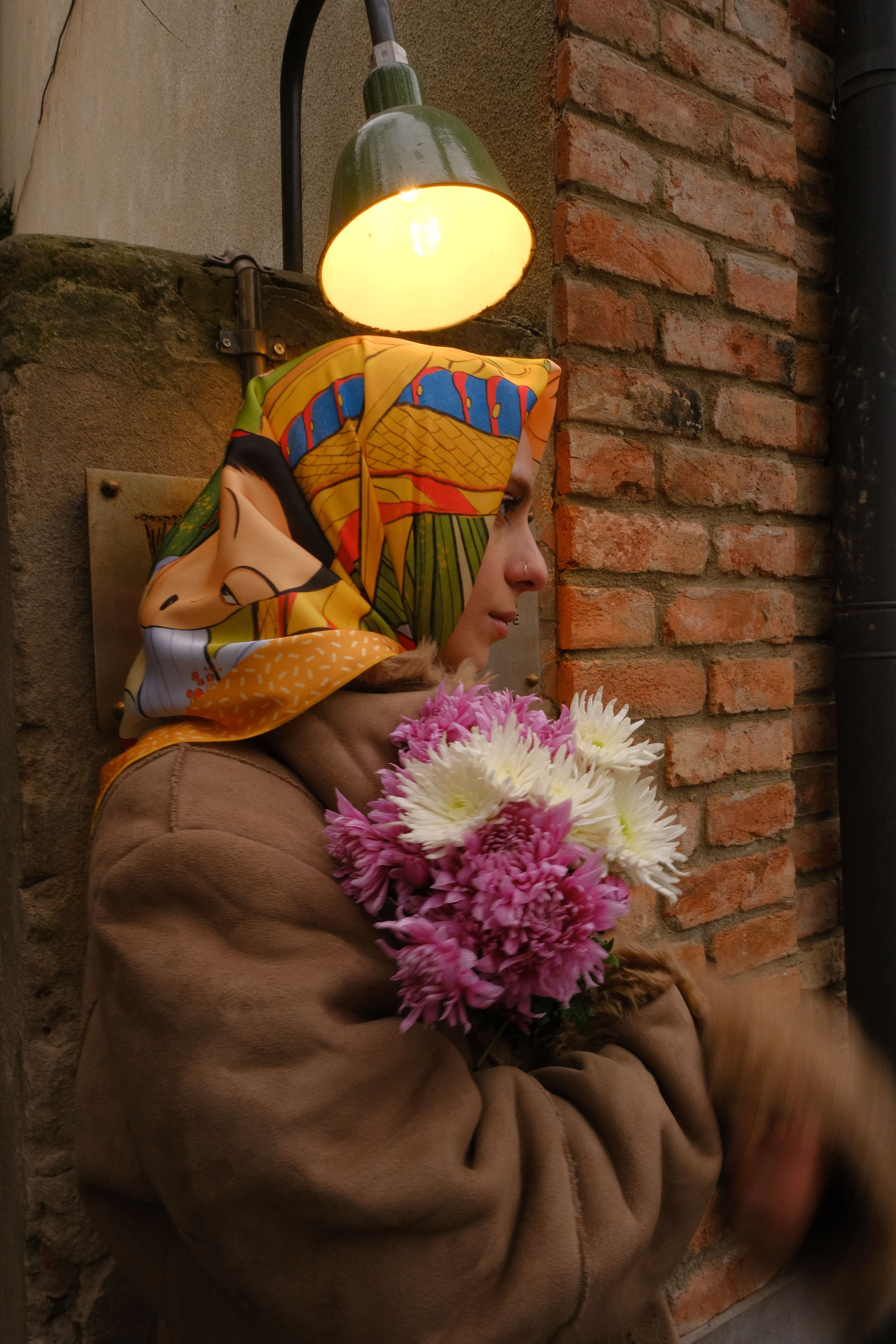 Lea Woo nature inspired scarf styled with flowers, model wearing it while holding flowers