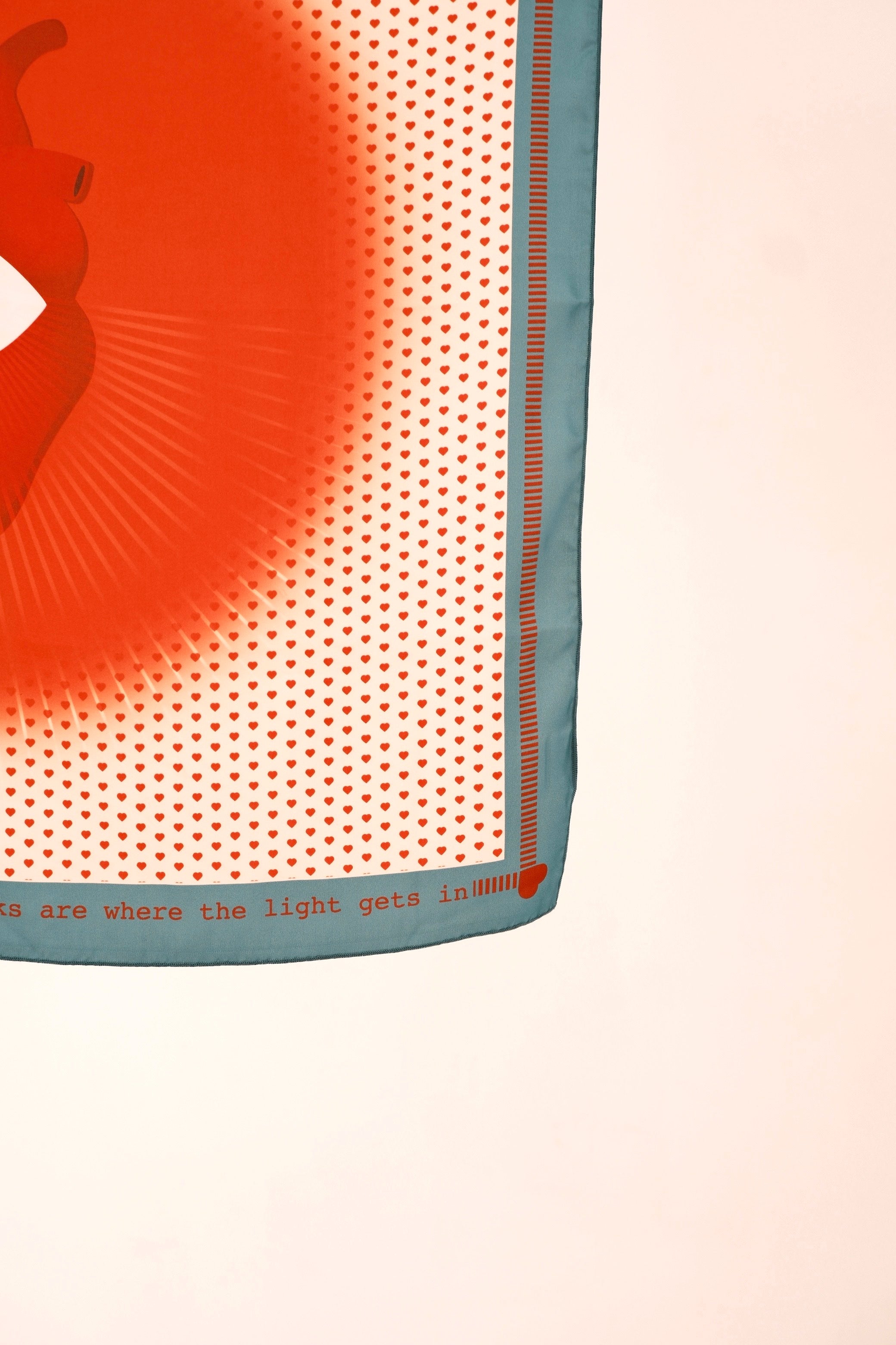 scarf with red design and text on a beige background