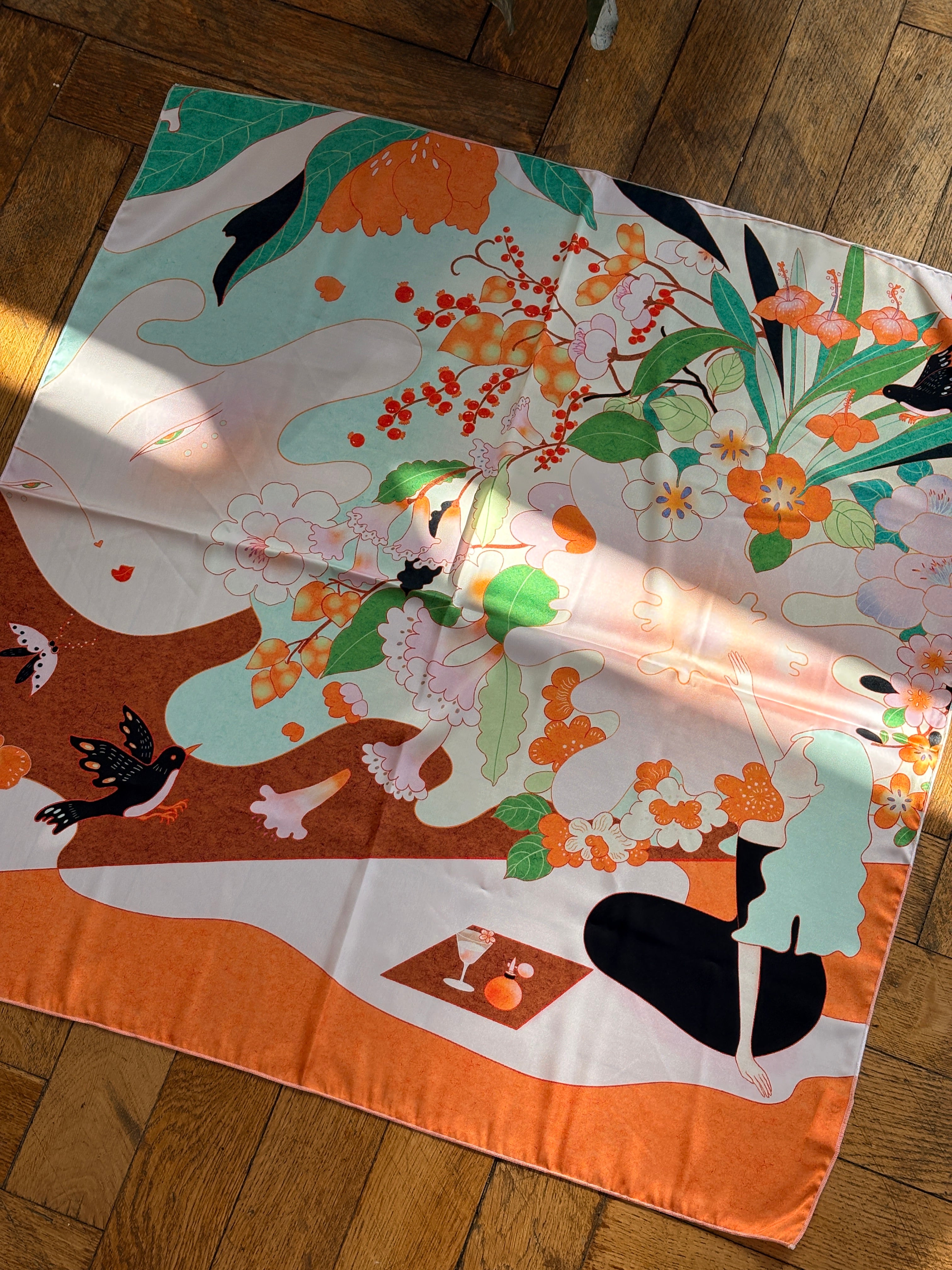 Colorful scarf with artistic design on a wooden surface