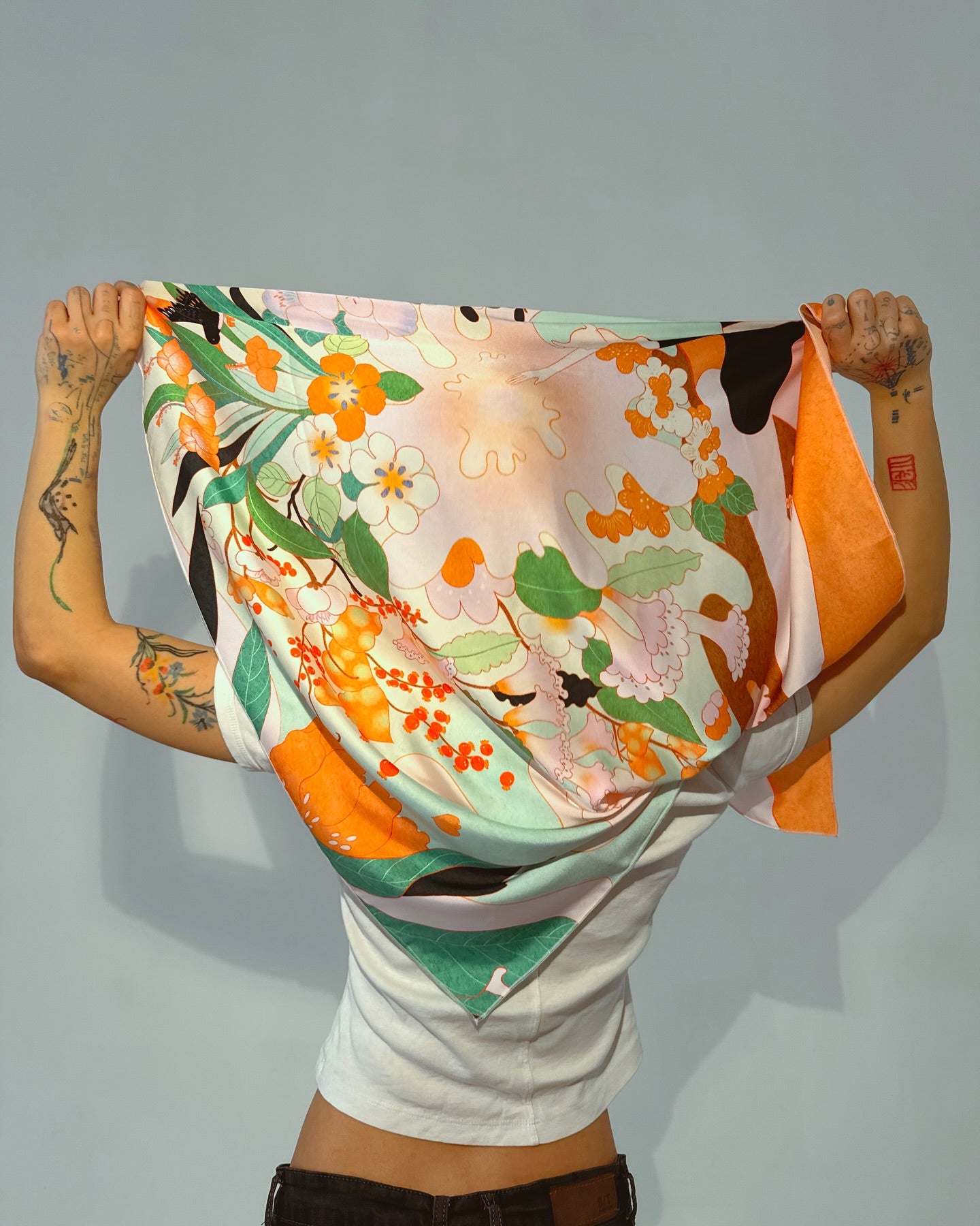 Close-up of Blossom silk scarf with nature-inspired artwork