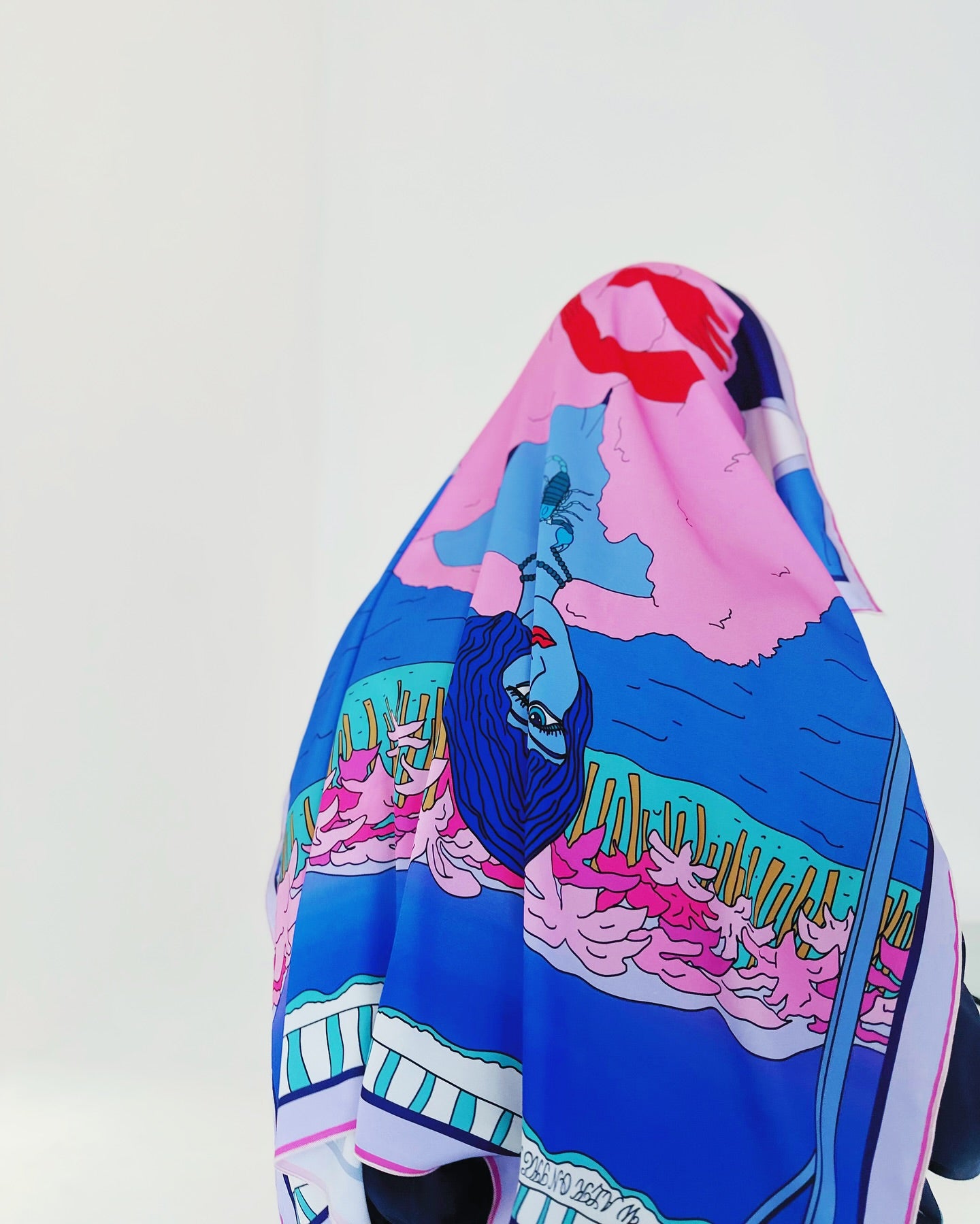 Scorpio zodiac art silk scarf hanging upright, showing expressive geometric and symbolic motifs