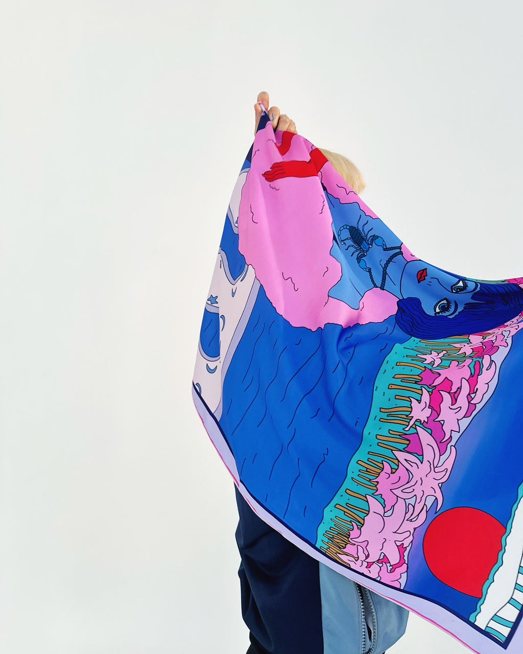 Scorpio zodiac illustrated scarf styled as a headwrap with vivid magenta and blue color palette