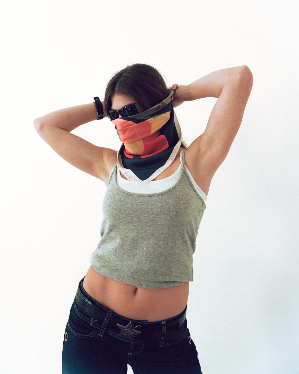 Person wearing a colorful bandana over their eyes on a white background