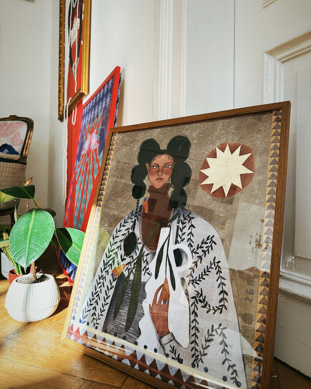 poster on the floor with design by german artist with sun plants and girl, in brown color