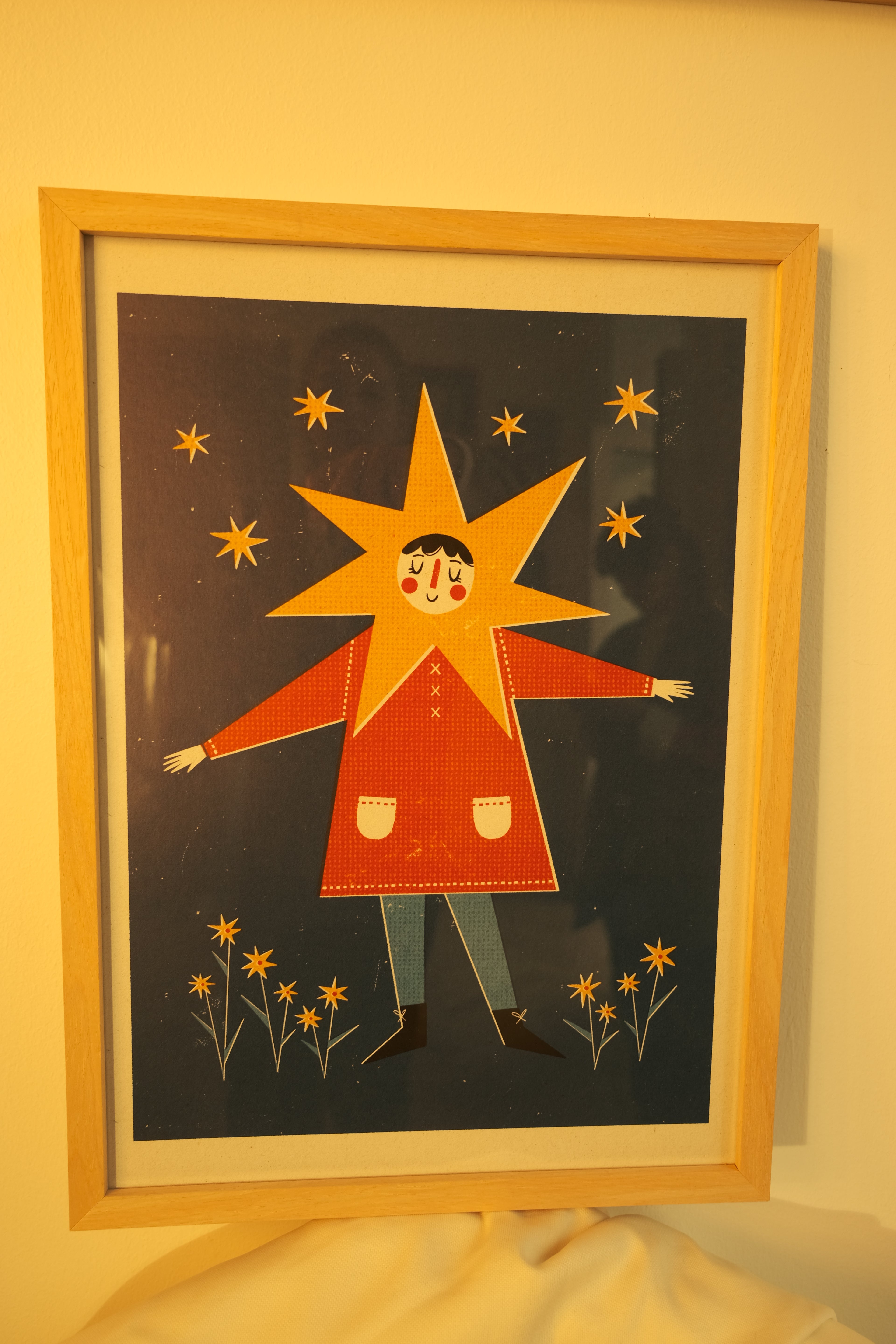 poster with illustration of girl standing in the field with stars and flowers, colors blue and red